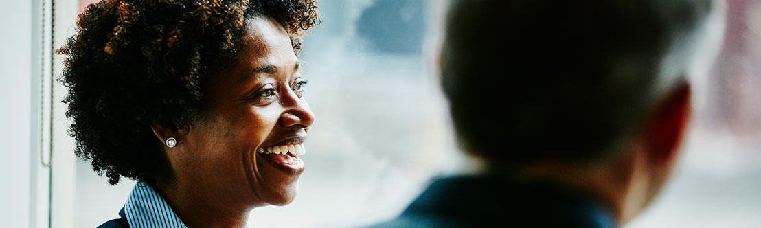 professional African American woman smiles at others