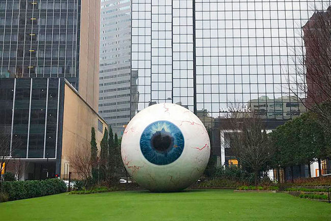 Huge eyeball sculpture on lawn in downtown Dallas