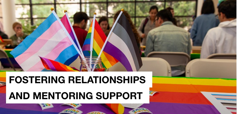 A rainbow table cloth and rainbow PRIDE flags on a table and the message fostering relationship and mentoring support