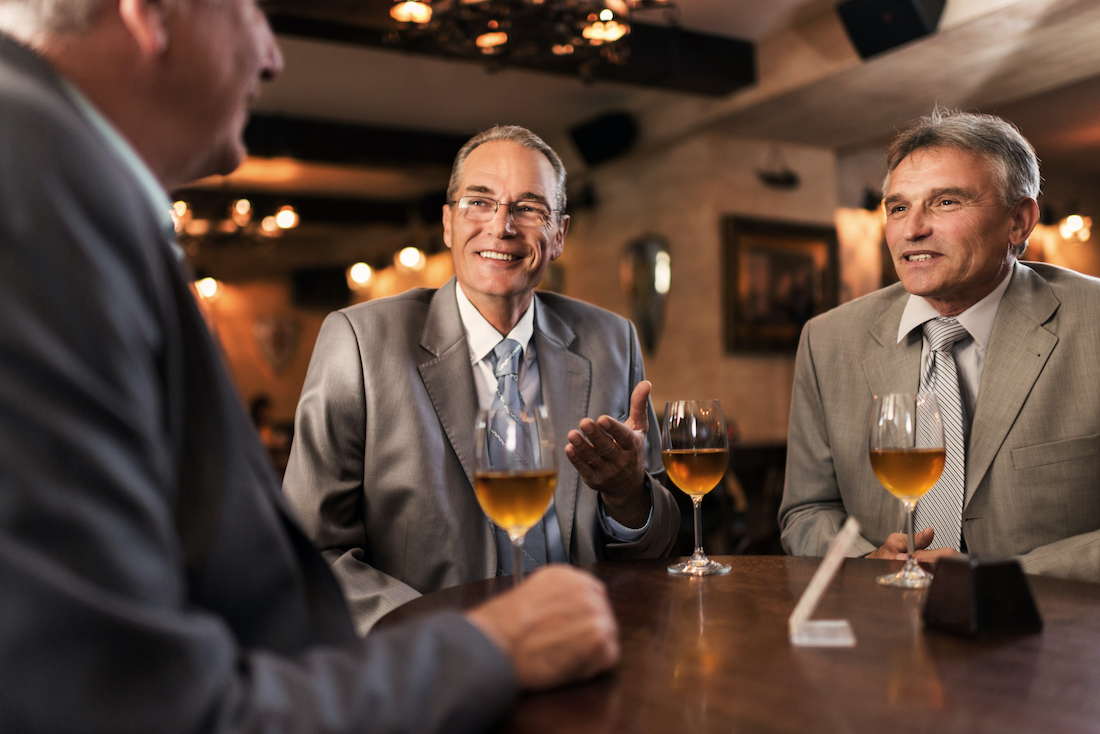 Businessmen communicating in the bar after work.