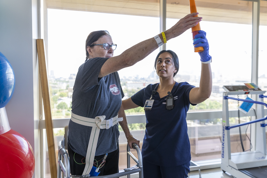 Stroke patient Linda Lewis receives assistance from occupational therapy nurse Ivo Edimo