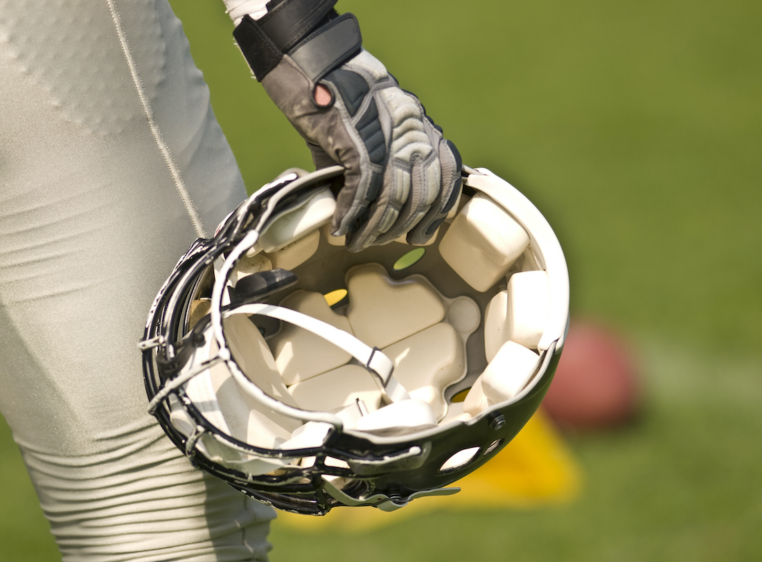 Football helmet in hand