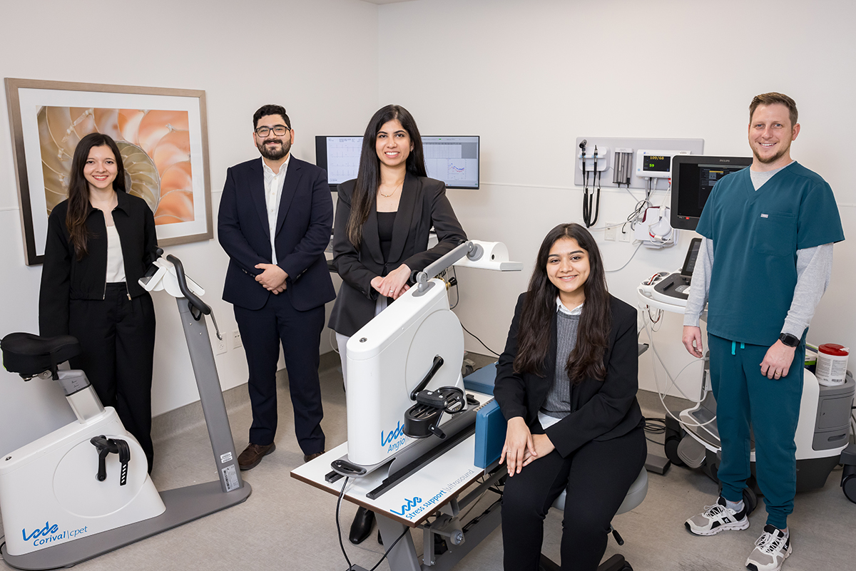 three women and 2 men standing in the cardiometabolic research unit physiology lab