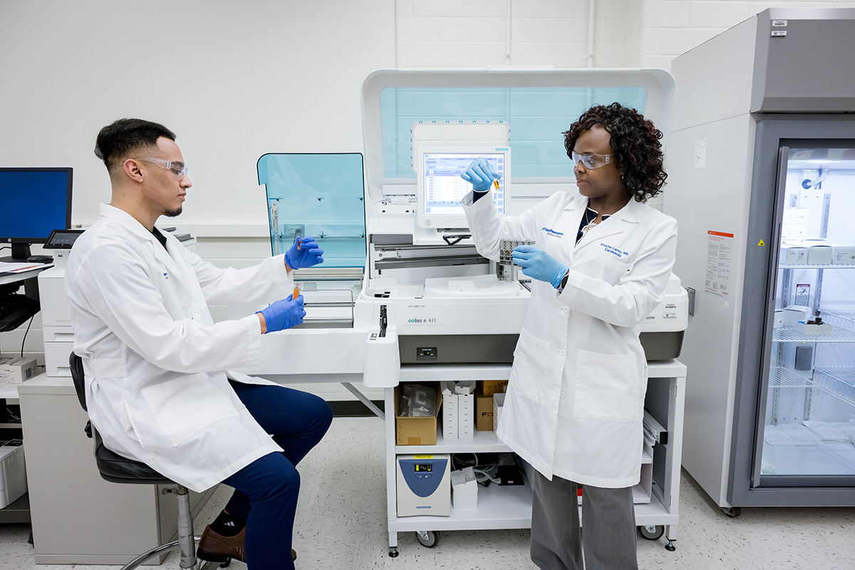 two lab members working in a laboratory setting