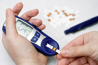 A glucose meter in a person's hand