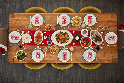 Overhead photo of holiday table with six chairs and place settings